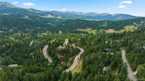 a view of a lush green hillside and houses