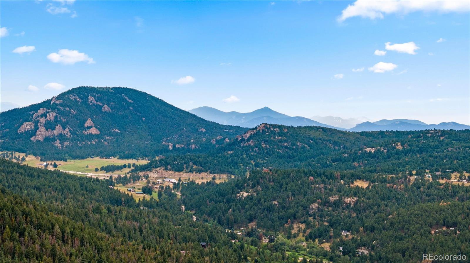 10126 Crest View Drive Morrison, CO 80465 - Photo 8 of 14 a view of a house with a mountain and a forest