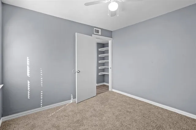 a view of an empty room with a fan