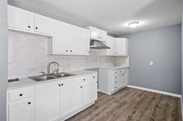 a kitchen with cabinets appliances and a sink