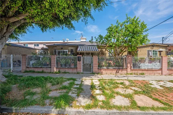 a view of a house with a yard and sitting area