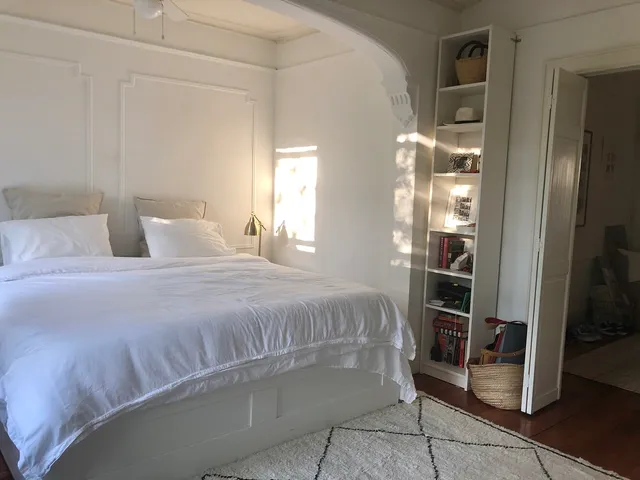 a bedroom with a bed and a window
