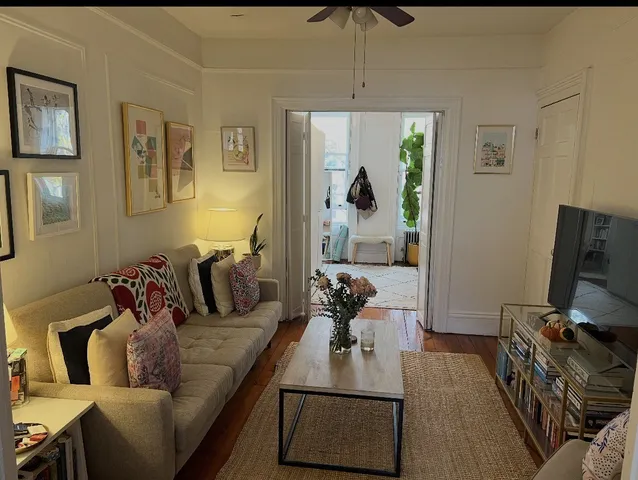 a living room with furniture and a flat screen tv