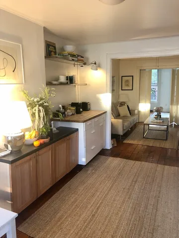 a kitchen with stainless steel appliances granite countertop a stove and wooden floors