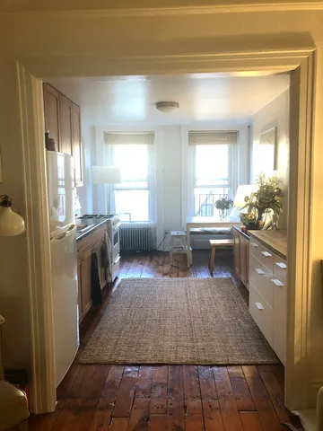 a large white kitchen with a large window