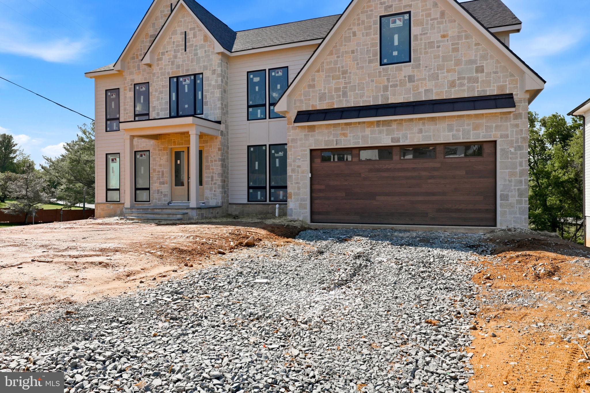 10801 Mason Hunt Court Reston, VA 20190 - Photo 4 of 26 a front view of a house with a yard