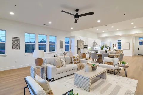 a living room with furniture and kitchen view