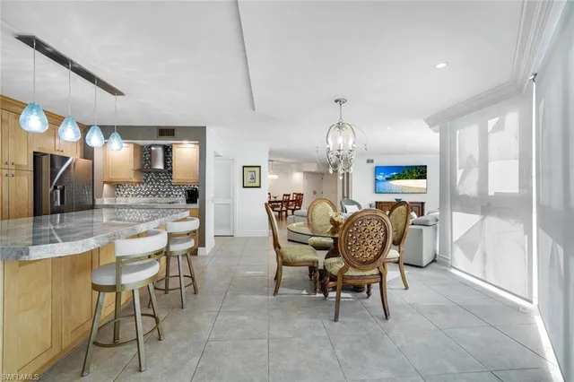 a dining room filled chandelier and fireplace