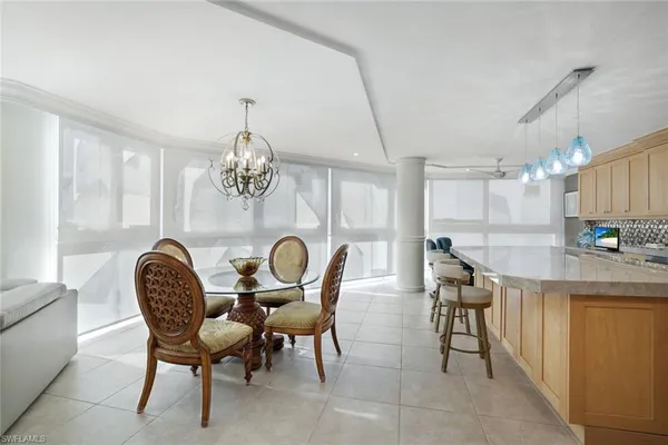 a dining room with furniture and a chandelier