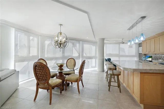 a dining room with furniture and a chandelier