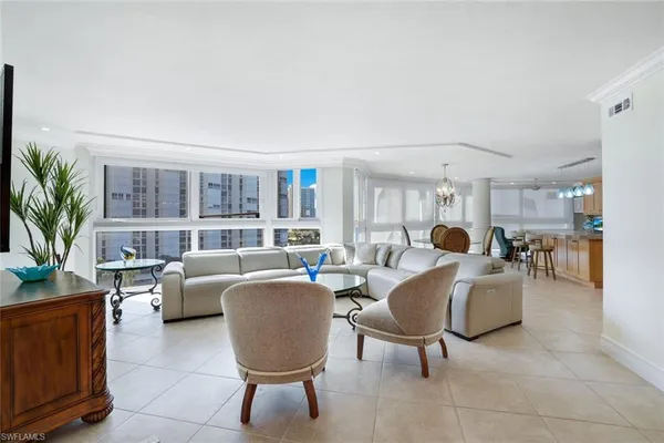 a living room with furniture potted plant and a window
