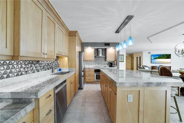 a kitchen with stainless steel appliances granite countertop a sink stove and cabinets