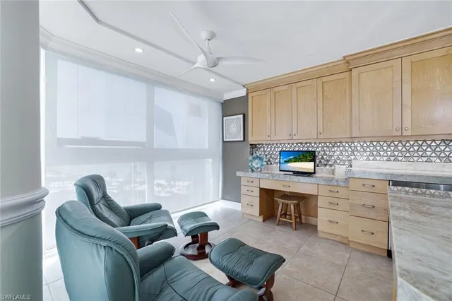 a living room with furniture a fireplace and kitchen view