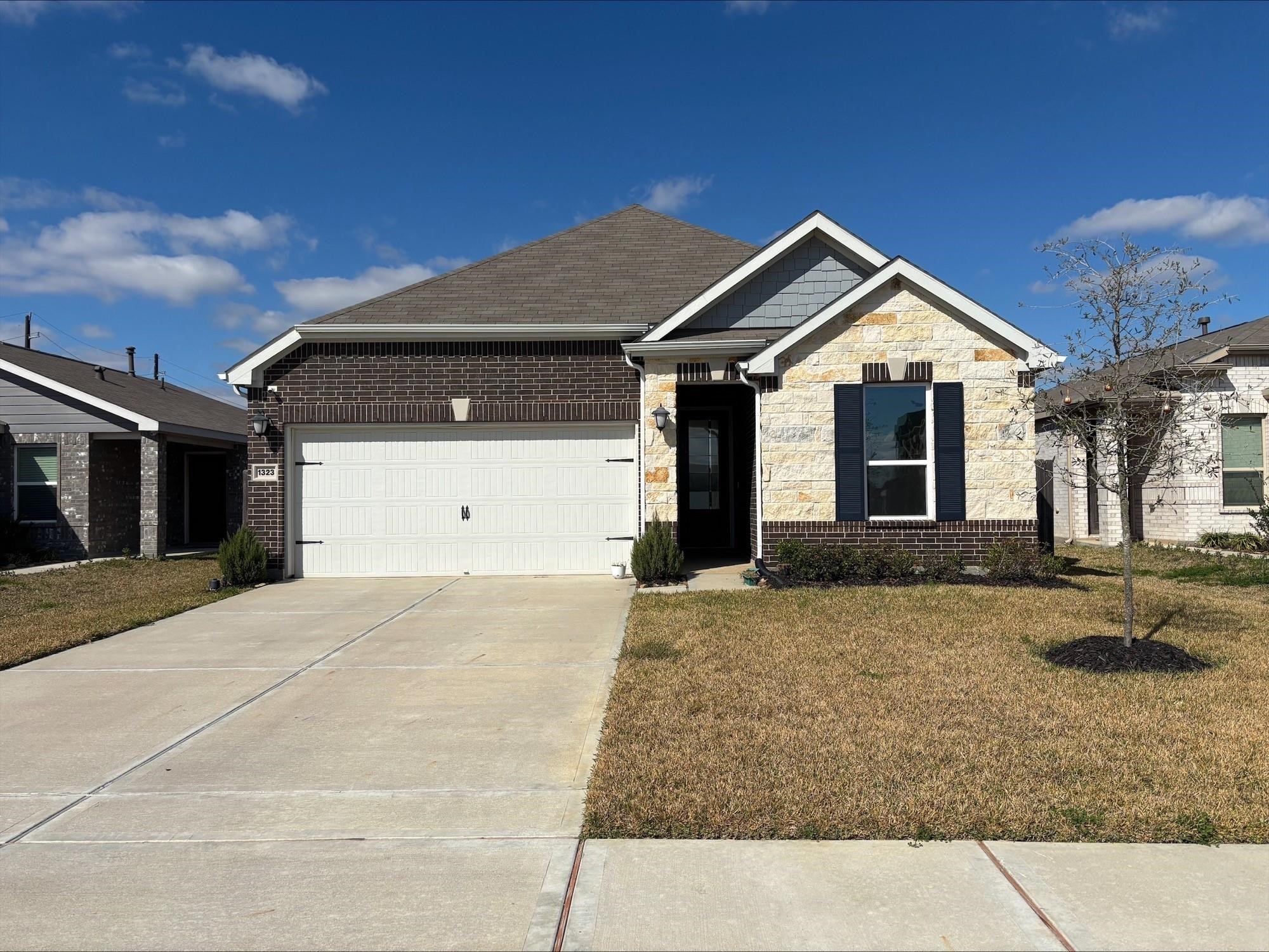 1323 Rosemead Drive Rosharon, TX 77583 - Photo 1 of 27 Discover your perfect home! This charming property boasts a spacious driveway, stunning brickwork, and inviting landscaping, all set against a clear blue sky.