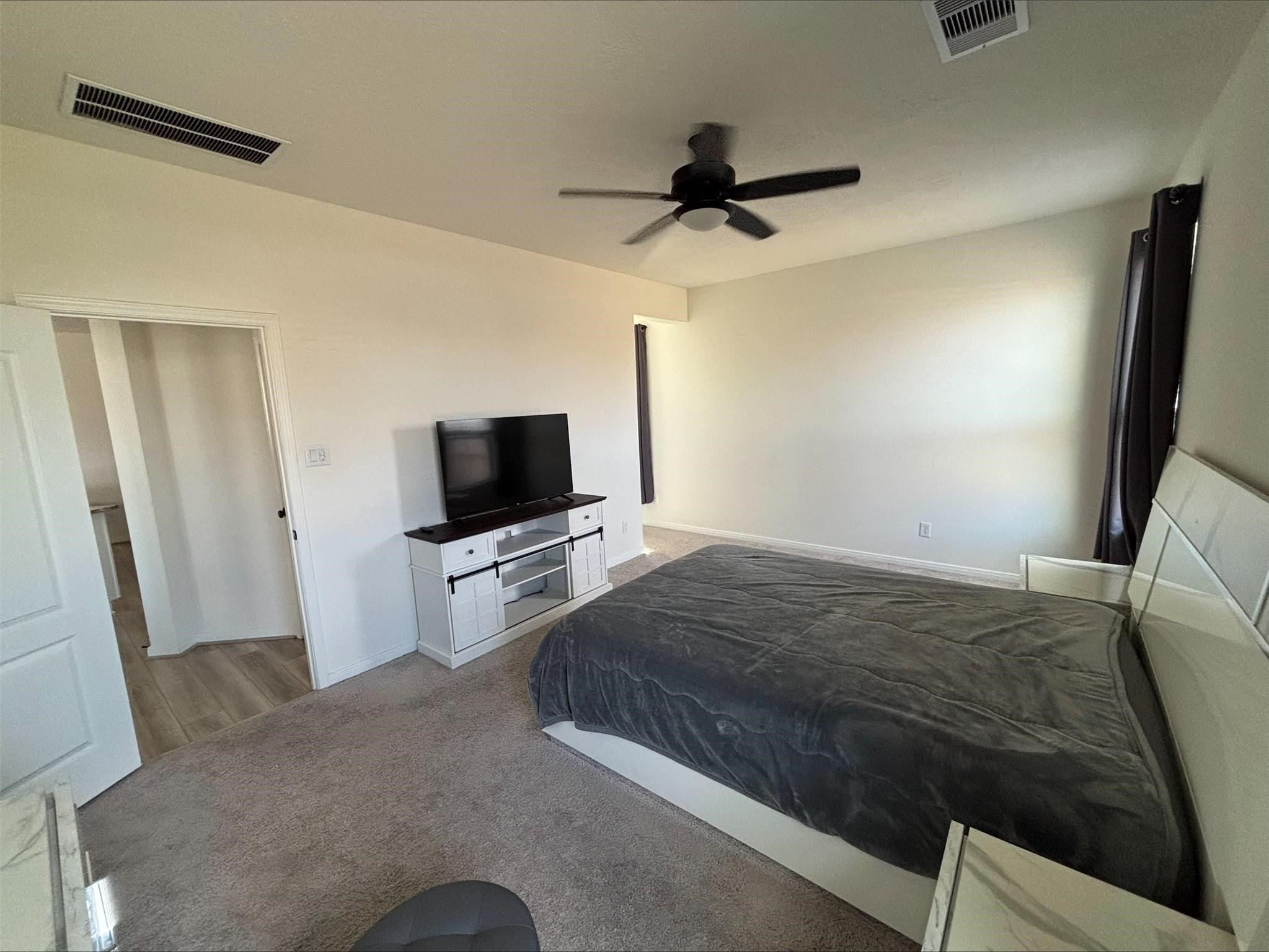 1323 Rosemead Drive Rosharon, TX 77583 - Photo 11 of 27 a bedroom with a bed and a flat screen tv