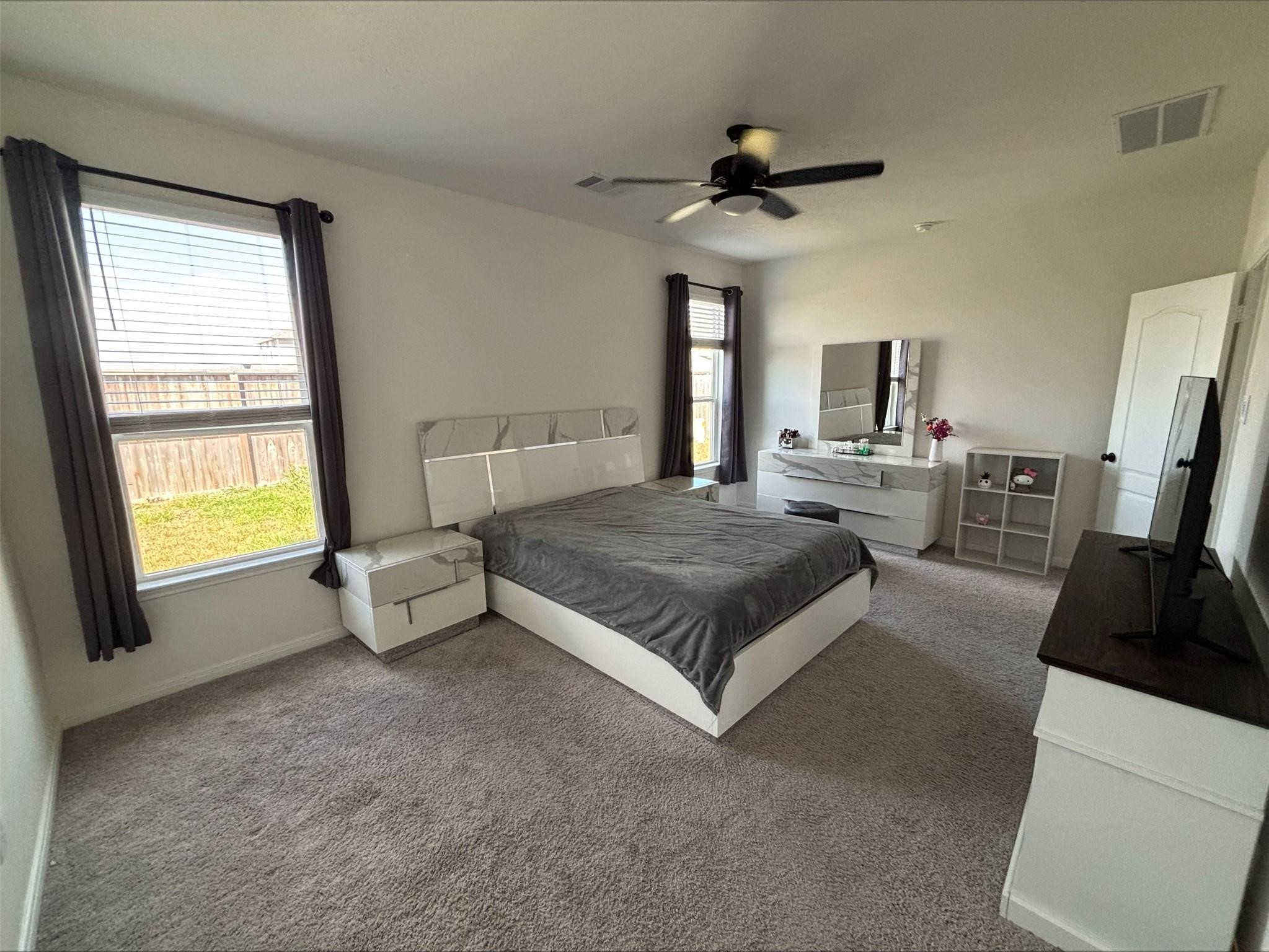 1323 Rosemead Drive Rosharon, TX 77583 - Photo 12 of 27 a spacious bedroom with a bed a fireplace and a large window