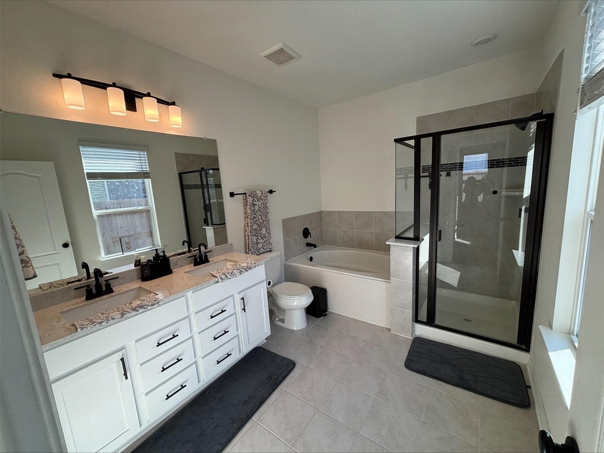 1323 Rosemead Drive Rosharon, TX 77583 - Photo 20 of 27 a spacious bathroom with a double vanity sink toilet mirror and shower