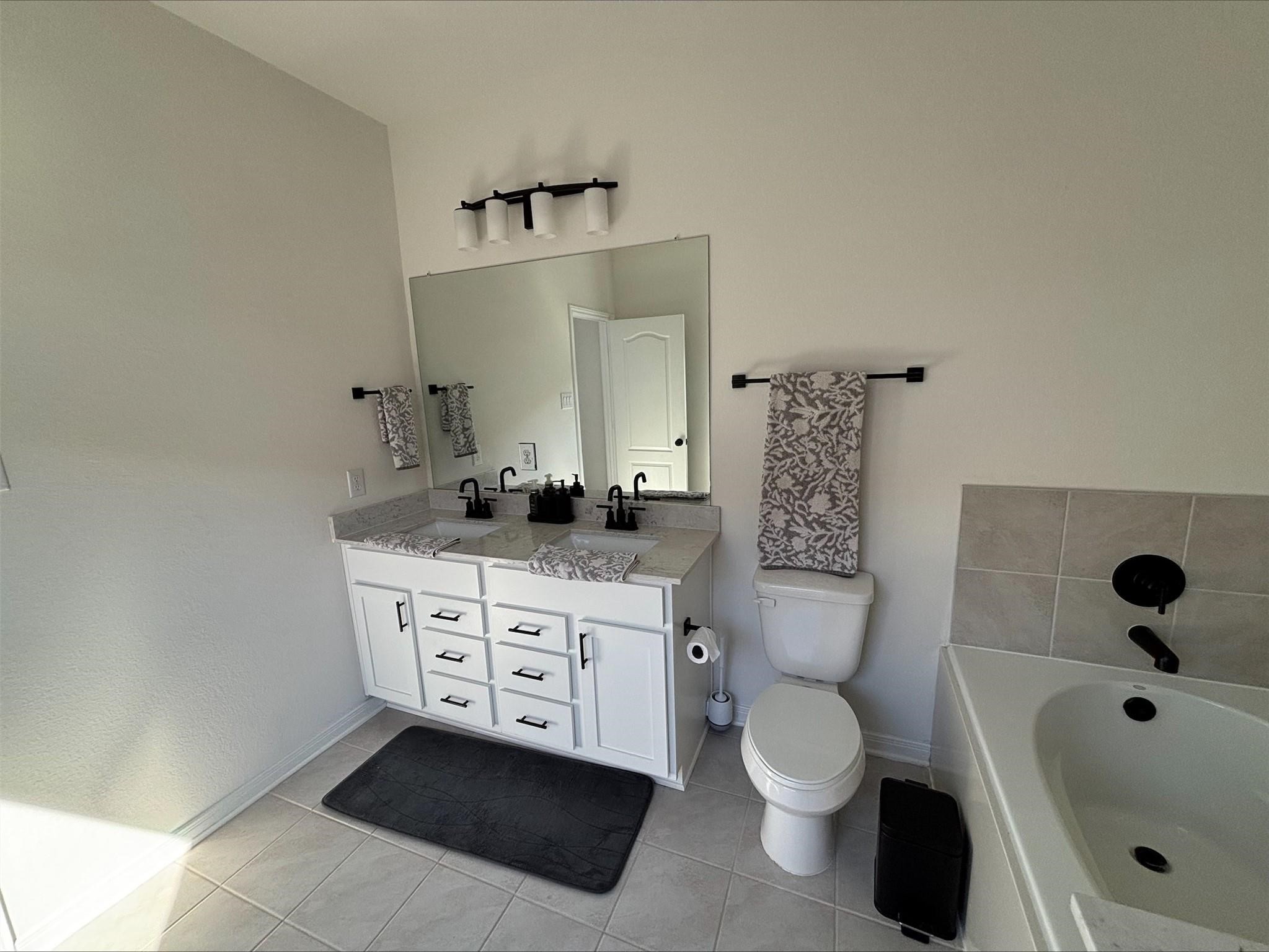 1323 Rosemead Drive Rosharon, TX 77583 - Photo 21 of 27 a bathroom with a toilet sink and mirror