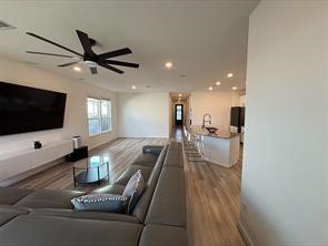 1323 Rosemead Drive Rosharon, TX 77583 - Photo 5 of 27 This inviting living area boasts modern elegance with an expansive layout, featuring a sleek sectional, stylish recessed lighting, and a state-of-the-art ceiling fan, perfect for relaxing or entertaining.
