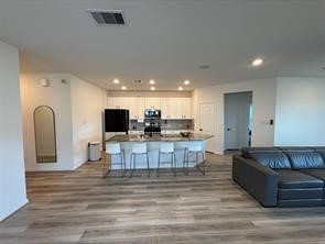 1323 Rosemead Drive Rosharon, TX 77583 - Photo 7 of 27 Experience modern living with this open-concept space featuring a sleek island kitchen perfect for entertaining and everyday comfort.