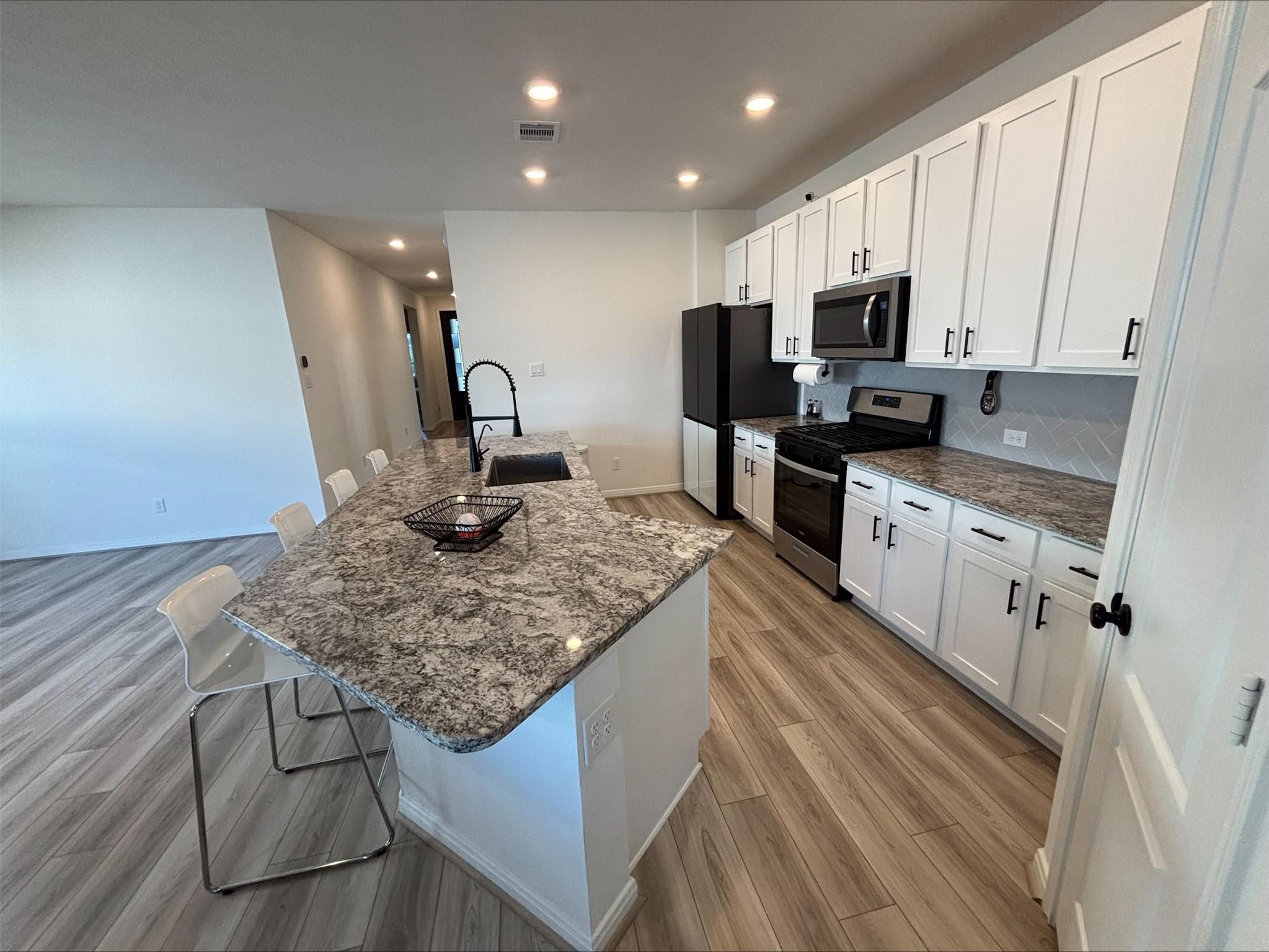 1323 Rosemead Drive Rosharon, TX 77583 - Photo 8 of 27 a kitchen with stainless steel appliances granite countertop a sink stove and refrigerator