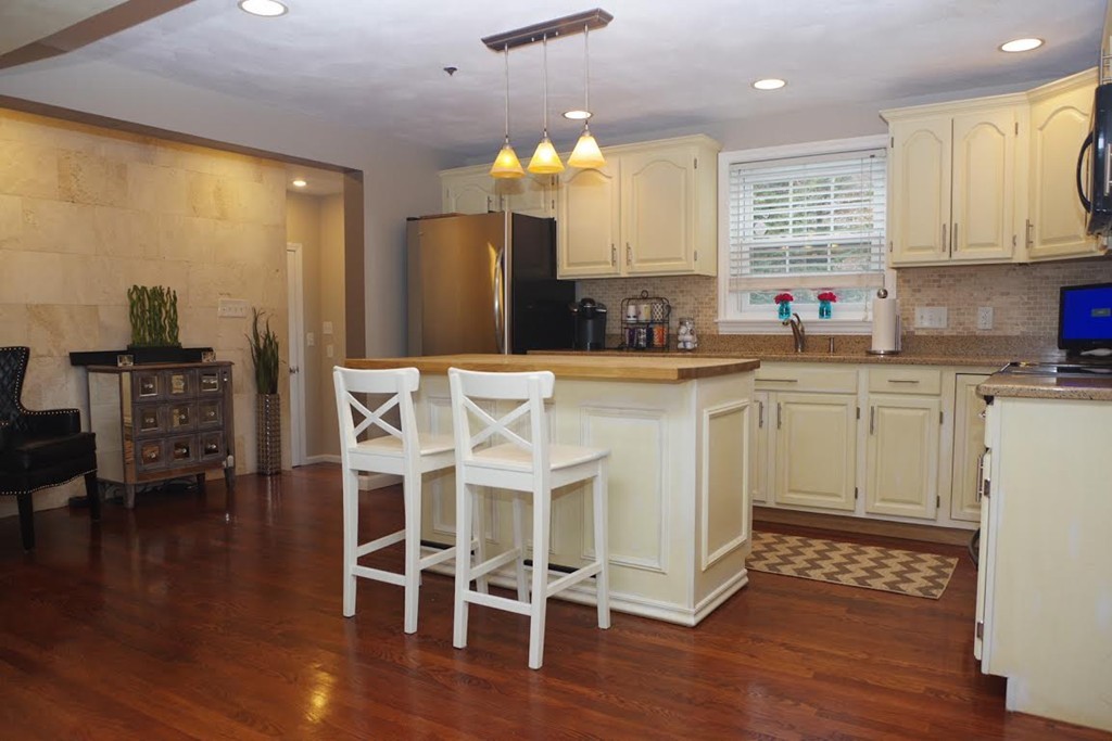2 Ridge Road Haverhill, MA 01830 - Photo 3 of 23 a kitchen with stainless steel appliances a dining table chairs and wooden floor