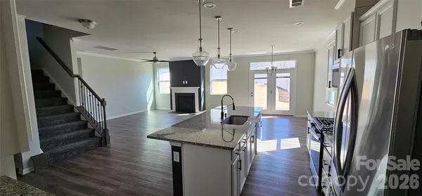 a kitchen with sink refrigerator and window