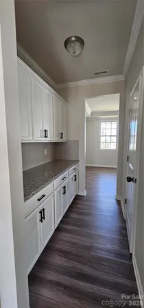 a kitchen with granite countertop white cabinets and white appliances