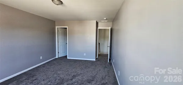 an empty room that has a grey walls