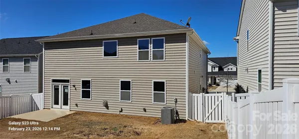 a view of a house with wooden fence