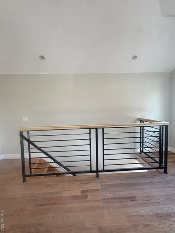 a view of a room with wooden floor and stairs