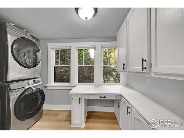 a view of a kitchen with washing machine and windows