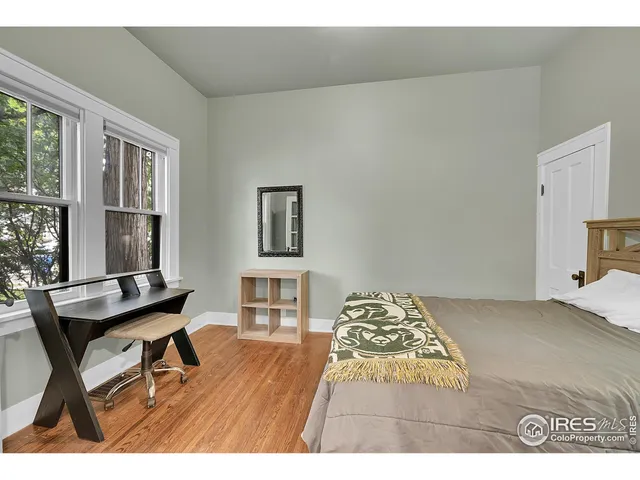 a bedroom with a bed and a table in it