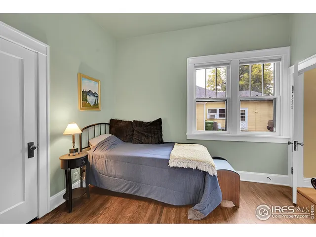 a bedroom with a bed and window