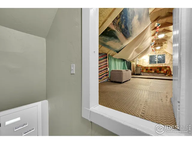 a living room with a couch and potted plant