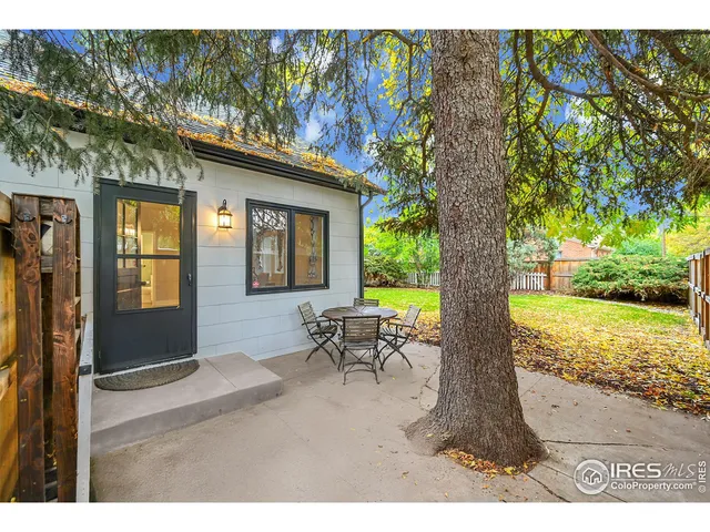 a view of a lounge chair in the porch next to a yard