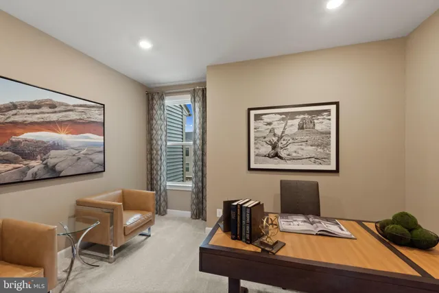 a view of a workspace with furniture and screen