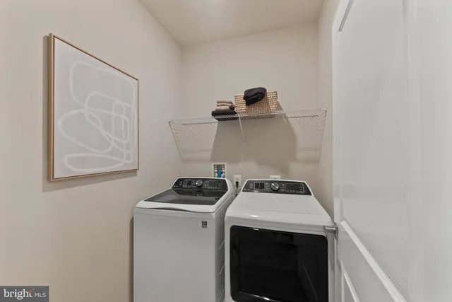 a view of storage and utility room with washer and dryer