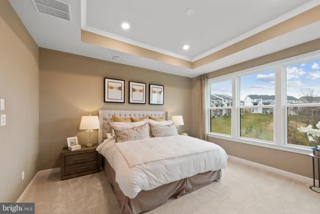 a bedroom with a large bed and a large window