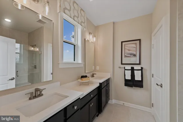 a bathroom with a sink double vanity and a shower