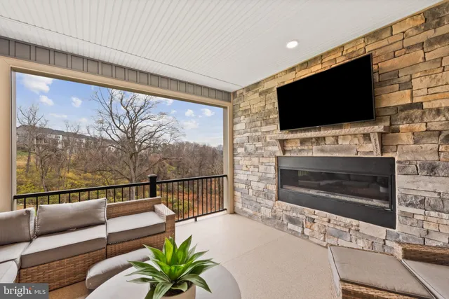 a living room with fireplace furniture and a flat screen tv
