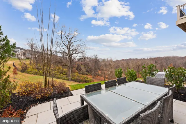 a view of a terrace with a table and chairs