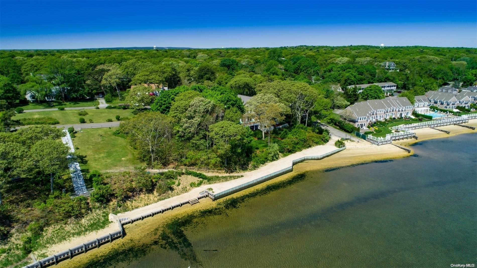 11 Bayview Drive Hampton Bays, NY 11946 - Photo 1 of 1 a view of a lush green outdoor space with a lake view