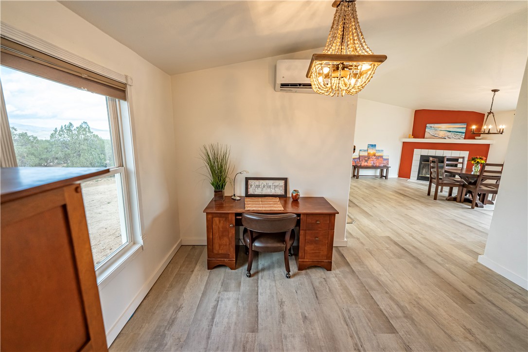 2765 North Silver Springs Road Kingman, AZ 86401 - Photo 45 of 60 a view of a dining room with furniture a chandelier and wooden floor
