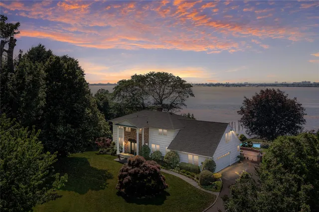 a view of a house with a yard and lake view