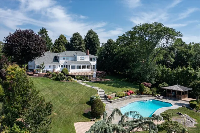 an aerial view of a house with a yard basket ball court and outdoor seating