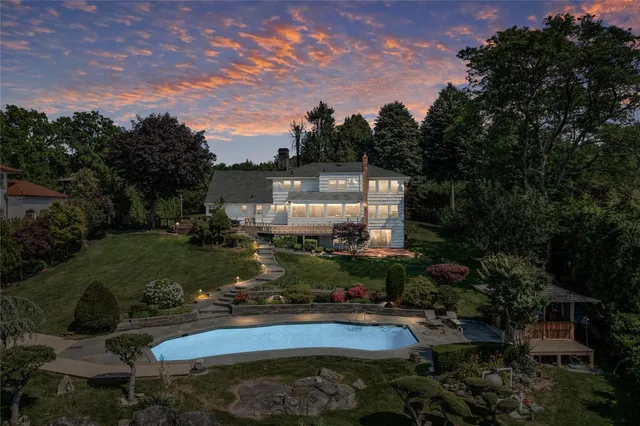 an aerial view of a house a yard and swimming pool