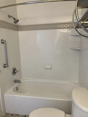 a bathroom with a shower and a bath tub