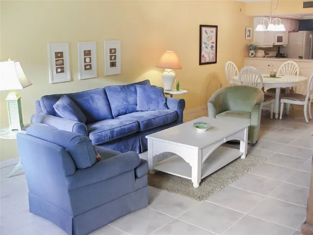 a living room with furniture and a lamp