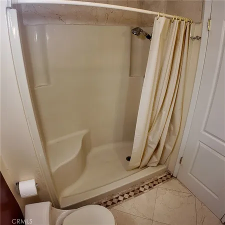 a bathroom with a window and a shower